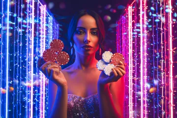 A cheerful woman in traditional clothing using her smartphone during a festive moment, showing how easily the 88FD app fits into everyday life.