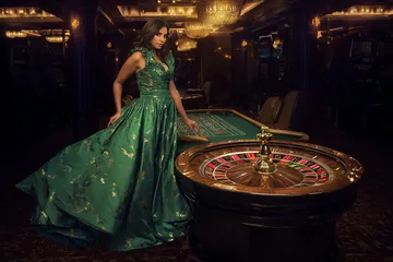 A man celebrating a winning moment on his laptop while gaming symbols float around him, capturing the excitement of 88FD games.