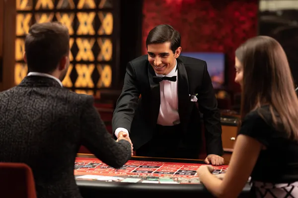 A woman in a luxurious green gown next to an ornate roulette wheel, capturing the upscale casino mood of 88FD.